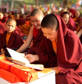 young monks reading in the new dharma books provided during the Worl Peace Ceremony
		