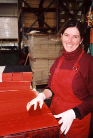 Volunteer coloring the dharma books with red